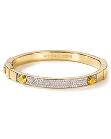 This Michael Kors bangle elevates simple style in gold tone plated metal with delicate crystal stones. Slip it on for a hit of minimalist glamour.