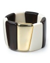 Trina Turnk's chunky teak and gold stretch cuff is an alluring statement piece. This accessory lends a natural, bohemian vibe, so wear it with breezy separates and flat sandals.