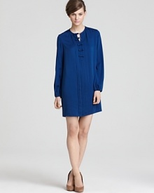 Referencing a return to the demure, this '50s-inspired DIANE von FURSTENBERG dress features pleats through the front with ladylike bows concealing snap closures. Pleated cuffs are the perfect finishing touch. Referencing a return to the demure, this '50s-inspired DIANE von FURSTENBERG dress features pleats through the front with ladylike bows concealing snap closures. Pleated cuffs are the perfect finishing touch.