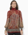 Lauren Ralph Lauren's breezy blouse is finished with a buttoned mockneck and elegant puffed sleeves.