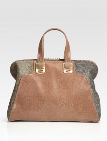 Downy calf hair and supple Italian leather, finished with goldtone hardware and a detachable shoulder strap.Top handles, 5 drop Removable, adjustable shoulder strap, 18-24 drop Top zip closure Protective metal feet One inside zip pocket Two open inside pockets Cotton lining 15W X 12H X 7D Made in Italy