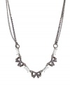 Fashionable and feminine. A trio of bows are adorned with glittering crystal accents on this stunning necklace from Betsey Johnson. Crafted in hematite tone mixed metal, it features textured ring details and chain embellishment. Approximate length: 16 inches + 3-inch extender.