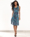 Dazzle from day to play with INC's sleeveless dress, finished by a bold print and belted waist.