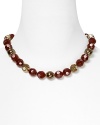 Red and bronze faceted beads lend rich shine to this necklace from Carolee.