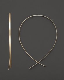 An inverted hoop earring in 14 Kt. gold, with thread-through closure. Designed by Lana.