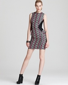 Rock downtown cool in this Milly mini dress, boasting a bold zigzag print juxtaposed against solid side panels with ruffle peplums. An exposed back zipper continues the edgy look, perfectly punctuated with wedge booties and an armful of metallic bangles.