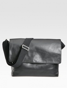 A stylish leather messenger bag to hold your every file and gadget.Flap-top snap closureAdjustable shoulder strapExterior slit pocketInterior laptop compartment with snap closureLeatherCotton lining14½W X 11H X 5½DImported A stylish leather messenger bag to hold your every file and gadget.Flap-top snap closureAdjustable shoulder strapExterior slit pocketInterior laptop compartment with snap closureLeatherCotton lining14½W X 11H X 5½DImported