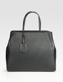 A roomy style in luxurious leather and matching coated twill with signature hardware.Double coated twill top handles, 6¼ dropSnap strap closure with center claspProtective metal feetOne inside zip pocketFully lined15W X 13½H X 6½DMade in Italy A roomy style in luxurious leather and matching coated twill with signature hardware.Double coated twill top handles, 6¼ dropSnap strap closure with center claspProtective metal feetOne inside zip pocketFully lined15W X 13½H X 6½DMade in Italy