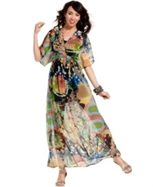Let your inner gypsy out! This fabulously florid sheer maxi dress from American Rag has flowing sleeves and a gorgeous harmony of patterns for a free-spirited look! Let your inner gypsy out! This fabulously florid sheer maxi dress from American Rag has flowing sleeves and a gorgeous harmony of patterns for a free-spirited look!