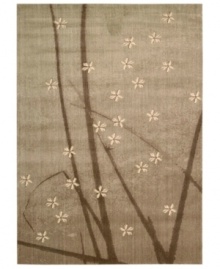 Add a nature-inspired touch to your home with this blossom-strewn rug by Calvin Klein. Accented with striking blades of grass against night-gray air, this fashionable piece is woven from a soft, yet durable wool blend. Add a nature-inspired touch to your home with this blossom-strewn rug by Calvin Klein. Accented with striking blades of grass against night-gray air, this fashionable piece is woven from a soft, yet durable wool blend.