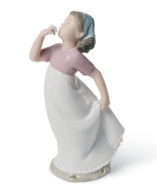 A young girl welcomes the first scent of spring in this charming handmade porcelain figure from Lladró. A young girl welcomes the first scent of spring in this charming handmade porcelain figure from Lladró.