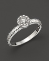 Faceted diamond set in a textured 14K. white gold band.