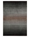 An ombré ground of soothing grays evokes mysterious allure in this area rug from Nourison. Hand tufted of long polyester fibers for added strength and softness, the Contour area rug creates an ideal accent for any modern room.