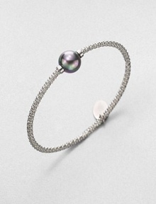 A stunning grey pearl on a textured, rhodium-plated stainless steel bangle. 12mm organic grey round man-made pearlRhodium-plated stainless steelDiameter, about 2.5Slip-on styleImported