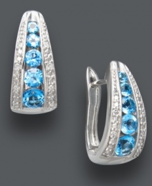Traditional hoops in bold, blue hues. Classic J-hoop earrings receive a sparkling touch with round-cut blue topaz (1-1/2 ct. t.w.), round-cut diamonds (1/10 ct. t.w.), and a polished sterling silver setting. Approximate diameter: 1/2 inch. Traditional hoops in bold, blue hues. Classic J-hoop earrings receive a sparkling touch with round-cut blue topaz (1-1/2 ct. t.w.), round-cut diamonds (1/10 ct. t.w.), and a polished sterling silver setting. Approximate diameter: 1/2 inch.
