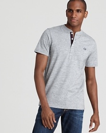 The signature Fred Perry logo accents the left chest of this reliable and handsome henley tee. The signature Fred Perry logo accents the left chest of this reliable and handsome henley tee.