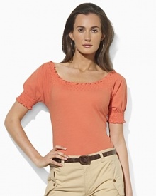 Imbued with breezy bohemian style, a soft cotton jersey top gets a romantic update with a smocked neckline and cuffs.