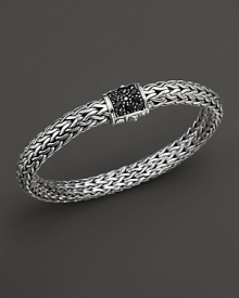 A pavé clasp of black sapphires anchors intricately woven sterling silver.