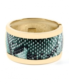 Slip on serpentine style for a fierce, overall effect. Haskell's chic cuff bracelet features a gold tone mixed metal setting that highlights a strip of teal snake print. Hinged design slips easily over the wrist. Approximate length: 8 inches.