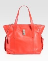 Sumptuous leather in a top-handle carryall finished zipper details and silvertone pyramid studs.Double top handles, 7½ dropTop zip closureTwo inside open pocketsCotton lining13W X 12H X 6DMade in Italy