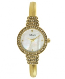 Put your best foot forward with this gleaming watch by Style&co. Gold tone mixed metal bangle bracelet and round case with crystal-accented link. Bezel embellished with crystal accents. Mother-of-pearl dial features four gold tone dot markers, three hands and logo. Quartz movement. Two-year limited warranty.