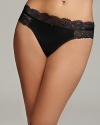 A soft thong with intricate floral lace trim along waist and hips, a sultry style from Calvin Klein.