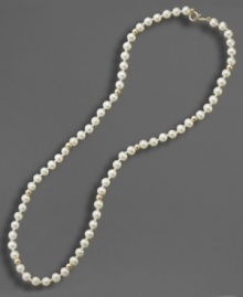 A dash of regal elegance, fit for the little lady. This simulated pearl necklace is studded with 14k gold beads and measures approximately 15 inches long. A dash of regal elegance, fit for the little lady. This simulated pearl necklace is studded with 14k gold beads and measures approximately 15 inches long.