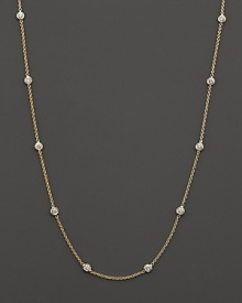 Diamond stations punctuate a long, elegant 18K yellow gold chain. By Roberto Coin.