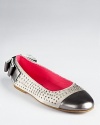 A glamorous update to her favorite flats, the Rabina sports shiny studs, a polished toe and double bow detail at the heel.