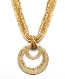 Get glamorously gilded! Style&co.'s luminous pendant features a graduated, cut-out circle pendant in hammered gold tone mixed metal strung from seven chic strands of seed beads. Approximate length: 18 inches + 2-inch extender. Approximate drop: 2-1/2 inches. Get glamorously gilded! Style&co.'s luminous pendant features a graduated, cut-out circle pendant in hammered gold tone mixed metal strung from seven chic strands of seed beads. Approximate length: 18 inches + 2-inch extender. Approximate drop: 2-1/2 inches.