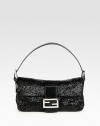 A sparkling style encrusted in baguette beads with luxurious leather trim and signature hardware.Adjustable shoulder strap, 5-8 dropSnap button flap closureOne inside zip pocketOne inside open pocketOne mirrorSatin lining9½W X 5½H X 2DMade in Italy