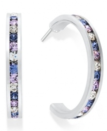Traditions gives a sparkling boost to a simple pair of hoop earrings. A channel-set row of round-cut purple crystal with Swarovski elements shines within a sterling silver setting. Earrings feature a post and stud backing. Approximate diameter: 3/4 inch. Traditions gives a sparkling boost to a simple pair of hoop earrings. A channel-set row of round-cut purple crystal with Swarovski elements shines within a sterling silver setting. Earrings feature a post and stud backing. Approximate diameter: 3/4 inch.