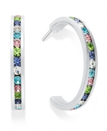 Traditions gives a sparkling boost to a simple pair of hoop earrings. A channel-set row of round-cut multicolored crystal with Swarovski elements shines within a sterling silver setting. Earrings feature a post and stud backing. Approximate diameter: 3/4 inch. Traditions gives a sparkling boost to a simple pair of hoop earrings. A channel-set row of round-cut multicolored crystal with Swarovski elements shines within a sterling silver setting. Earrings feature a post and stud backing. Approximate diameter: 3/4 inch.