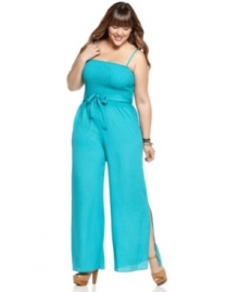 Sport a super-cute 70s look with American Rag's sleeveless plus size jumpsuit, accented by a smocked top and belted waist.