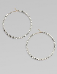 Hoops of 14k gold wire are set with faceted sterling silver beads that catch and reflect light with a warm radiance.14k yellow gold and sterling silverDiameter, about 1½Ear wireMade in USA Hoops of 14k gold wire are set with faceted sterling silver beads that catch and reflect light with a warm radiance.14k yellow gold and sterling silverDiameter, about 1½Ear wireMade in USA