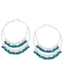 A stunning statement, twice over. These double hoop earrings are set in sterling silver and dazzle with beautiful turquoise (3/8 ct. t.w.) beads. Approximate diameter: 2 inches.