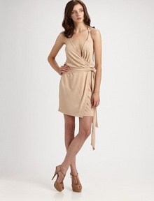 Sexy and sleek, in softly knit jersey accented with an attached self sash at the waist.Surplice halter necklineWrap frontSelf waist tieLow backAbout 18¼ from natural waistRayonDry cleanImportedModel shown is 5'9 (175cm) wearing US size Small. Sexy and sleek, in softly knit jersey accented with an attached self sash at the waist.Surplice halter necklineWrap frontSelf waist tieLow backAbout 18¼ from natural waistRayonDry cleanImportedModel shown is 5'9 (175cm) wearing US size Small.
