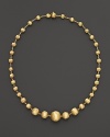 Gorgeously textured beads of 18K yellow gold gleam richly on this necklace from the Africa Collection.