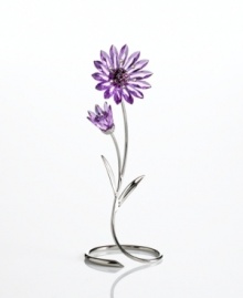In full and partial bloom, these violet crystal flowers signify an everlasting relationship. A silvertone stand balances the precious blossoms and a pair of delicate leaves. In full and partial bloom, these violet crystal flowers signify an everlasting relationship. A silvertone stand balances the precious blossoms and a pair of delicate leaves.