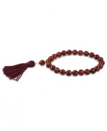 Totally on trend! Tassels are the thing this season, and this crimson-colored tassel and carnelian bead bracelet (109-3/8 ct. t.w.) completes the look. Set in 18k gold over sterling silver. Bracelet stretches to fit wrist. Approximate diameter: 2-1/4 inches. Approximate length: 7-1/2 inches. Totally on trend! Tassels are the thing this season, and this crimson-colored tassel and carnelian bead bracelet (109-3/8 ct. t.w.) completes the look. Set in 18k gold over sterling silver. Bracelet stretches to fit wrist. Approximate diameter: 2-1/4 inches. Approximate length: 7-1/2 inches.