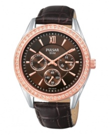 Like a freshly picked rose, this chic timepiece from Pulsar brings grace wherever it goes. Crafted of brown croc-embossed leather strap and round rose-gold tone stainless steel case. Bezel crystallized by Swarovski elements. Brown dial with rose-gold tone stick indices at markers, hour and minute hands, minute track, three subdials, logo and Roman numeral at twelve o'clock. Quartz movement. Water resistant to 50 meters. Three-year limited warranty. Like a freshly picked rose, this chic timepiece from Pulsar brings grace wherever it goes. Crafted of brown croc-embossed leather strap and round rose-gold tone stainless steel case. Bezel crystallized by Swarovski elements. Brown dial with rose-gold tone stick indices at markers, hour and minute hands, minute track, three subdials, logo and Roman numeral at twelve o'clock. Quartz movement. Water resistant to 50 meters. Three-year limited warranty.