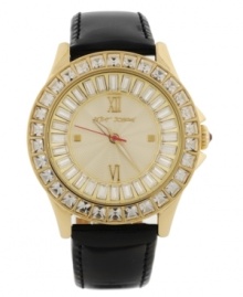 A classic boyfriend-style timepiece given a shot of glitzy glamour, by Betsey Johnson. Crafted of black leather strap and round gold tone stainless steel case. Bezel embellished with crystal accents. Textured champagne dial features ring of baguette-cut crystal accents, applied silver tone Roman numerals at twelve and six o'clock, dot markers at three and nine o'clock, luminous hour and minute hands, signature fuchsia second hand and logo at twelve o'clock. Quartz movement. Water resistant to 30 meters. Two-year limited warranty. A classic boyfriend-style timepiece given a shot of glitzy glamour, by Betsey Johnson. Crafted of black leather strap and round gold tone stainless steel case. Bezel embellished with crystal accents. Textured champagne dial features ring of baguette-cut crystal accents, applied silver tone Roman numerals at twelve and six o'clock, dot markers at three and nine o'clock, luminous hour and minute hands, signature fuchsia second hand and logo at twelve o'clock. Quartz movement. Water resistant to 30 meters. Two-year limited warranty.
