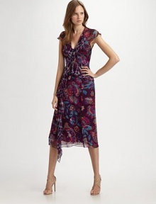 Wildly printed panels of floral and plaid silk chiffon define this ruffled, feminine design.Cap sleeves V neckline Ruffled peplum Asymmetrical front ruffle Back button closure About 30 from natural waist Silk Dry clean Made in USA of imported fabric