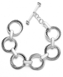 Uniquely updated. A classic chain link bracelet is a must-have for any jewelry collection, but this Lauren by Ralph Lauren version takes a chic, contemporary approach with its distinctive twist design. Set in silver tone mixed metal, it features a toggle closure. Approximate length: 8 inches.