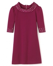 Vintage-chic gets the royal treatment with this berry hued Nicole Miller dress featuring sparkling rhinestones at the neck and cuffs. Vintage-chic gets the royal treatment with this berry hued Nicole Miller dress featuring sparkling rhinestones at the neck and cuffs.
