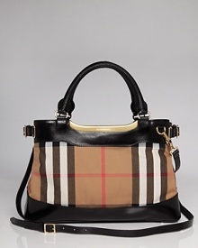 True to form, this Burberry satchel works a classic vibe in printed cotton with a versatile design that is perfect on the arm or across the body. True to form, this Burberry satchel works a classic vibe in printed cotton with a versatile design that is perfect on the arm or across the body.
