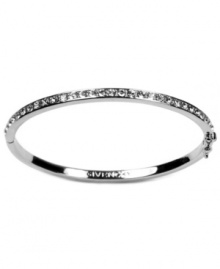 Polished and sleek. Givenchy's rhodium-plated silver tone bracelet features crystal glass stone detailing. Approximate diameter: 2-1/2 inches.