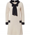 Put a sartorial spin on daytime sophistication in Moschinos sweet-chic two-tone sailor dress - Draped neckline with slit and tie, long sleeves, skirt with side pleating, black trim throughout, hidden back zip - Loosely tailored fit - Wear with patent leather flats and a chain-detailed handbag