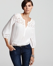 A silk BCBGMAXAZRIA top flaunts a chic lace yoke and lovely blouson sleeves for an easy season of romance and femininity.