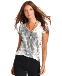 Infuse your casual look with an edgy touch in this graphic V-neck tee from Calvin Klein Jeans.